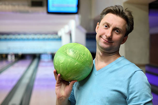 istock Portrait of man with ball for bowling 153564961