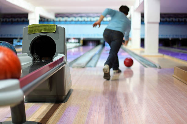 istock Man exactly throws up ball on skittles in bowling club 153564967