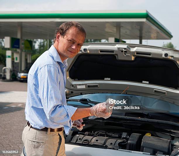 Checking Oil Levels Stock Photo - Download Image Now - Car, Dipstick, Adult