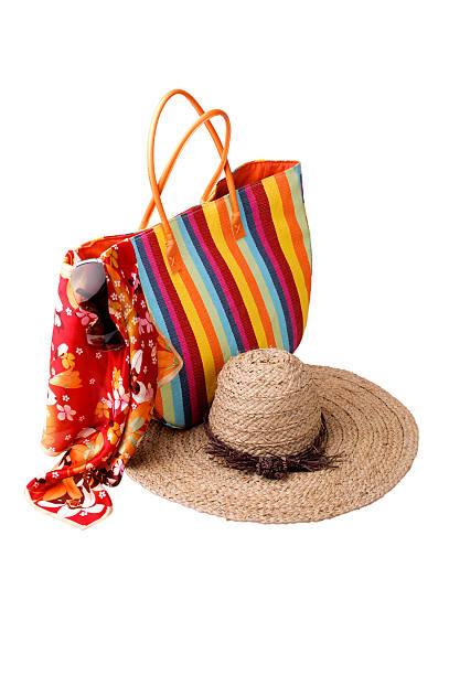 istock Beach items: colorful striped bag, bright kerchief, sunglasses a 153566923