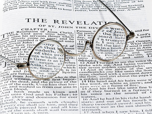 istock Antique reading glasses on page of bible 153566949