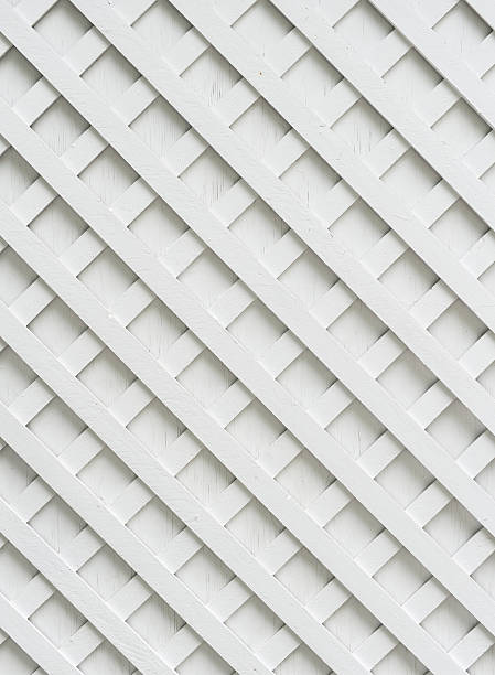 Criss Cross Shot of white garden lattice against a white wall. trellis photos stock pictures, royalty-free photos & images