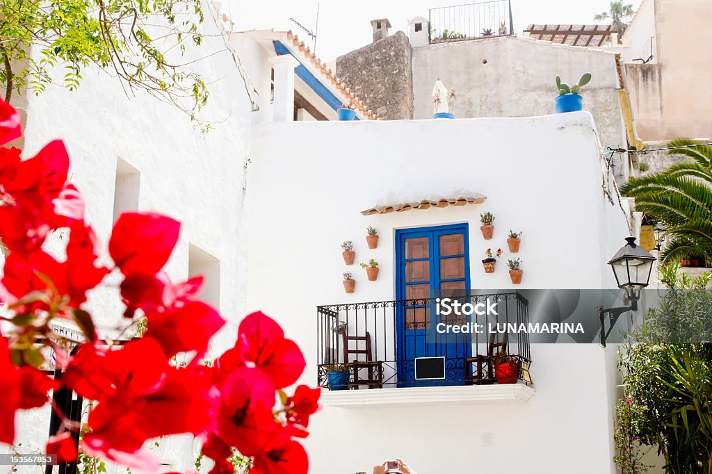 Ibiza island architecture with a terrace and red flowers Ibiza white island architecture corner bougainvilleas flowers Balearic Spain Architectural Feature Stock Photo