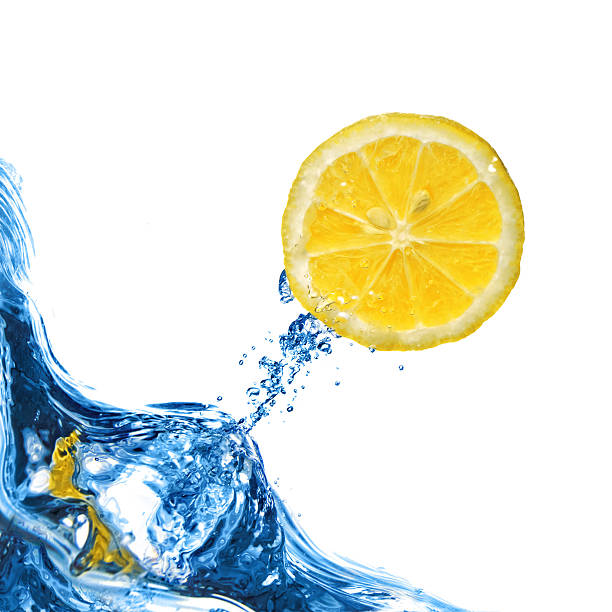 istock Fresh lemon fly out from blue water isolated on white 153568126