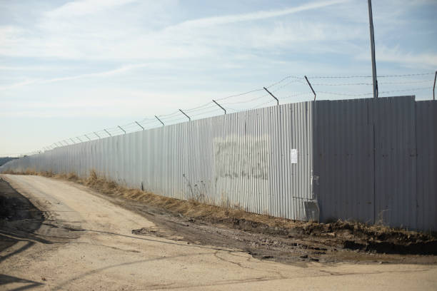 istock Fence in industrial zone. Road along territory. Passage between fences. 1535687997
