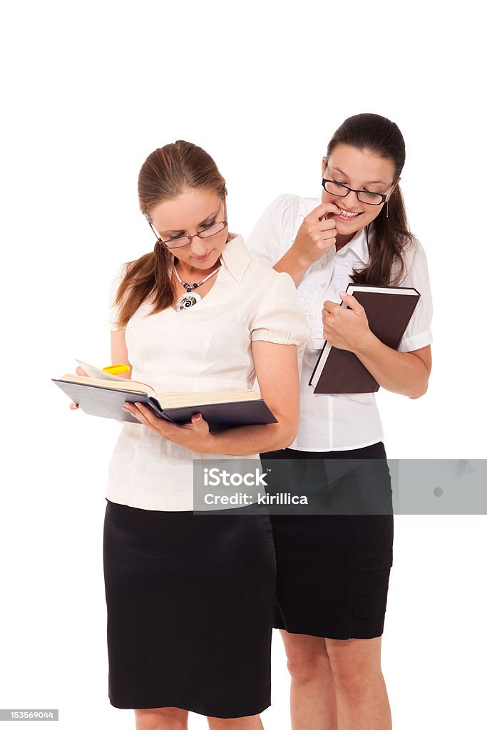 What do you read? Two student girls are reading the same book. Adult Stock Photo