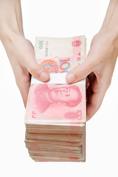 Human hand holding thousands china's currency stock photo