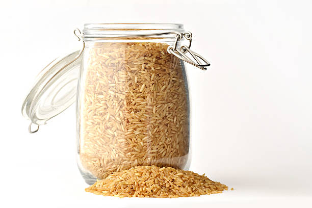 istock Pile and jar with brown rice 153569811