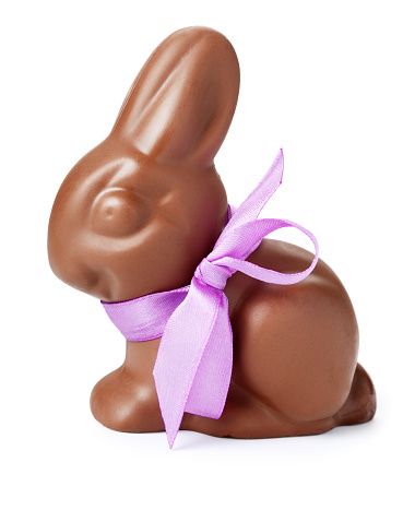 Chocolate rabbit with purple ribbon. Isolated on white.