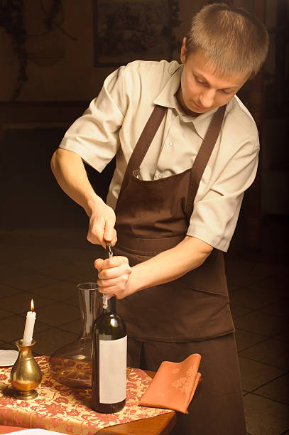 istock Sommelier opening wine bottle for blind winetasting 153570214
