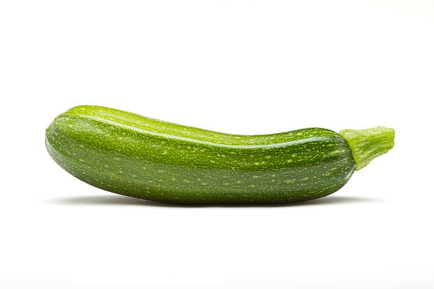 courgette Single Courgette or zucchini from low perspective isolated on white. courgette stock pictures, royalty-free photos & images