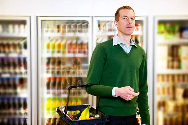 Portrait of a man looking at the camera in a grocery store