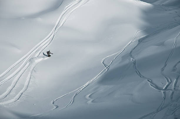 istock Snowboarder following tracks in the snow 153572742