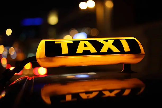 Yellow taxi sign illuminated at night