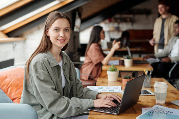 istock Young smiling female analyst or economist looking at camera by workplace 1535734427