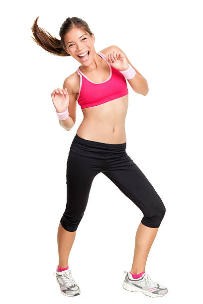 Dance fitness woman dancing Zumba fitness woman dancing isolated on white in full body. Beautiful, happy and smiling young female fitness instructor during dance class. Mixed race Caucasian Asian female fitness model. Click for more dance studio instructor stock pictures, royalty-free photos & images