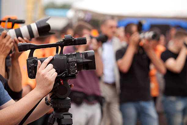 istock Covering an event with a black video camera 153573673