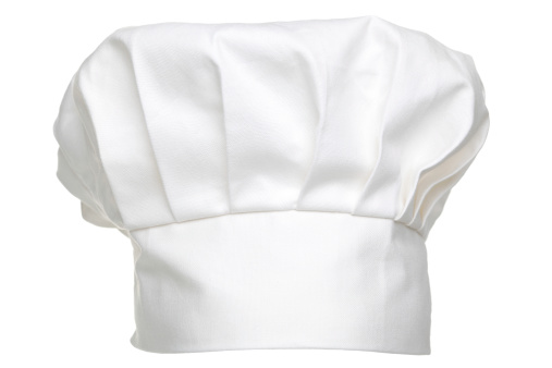 Photo of a chefs hat traditionally called a toque blanche, isolated on a white background.