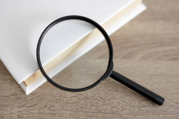 istock close up of book and magnifying glass on the table 1535740231