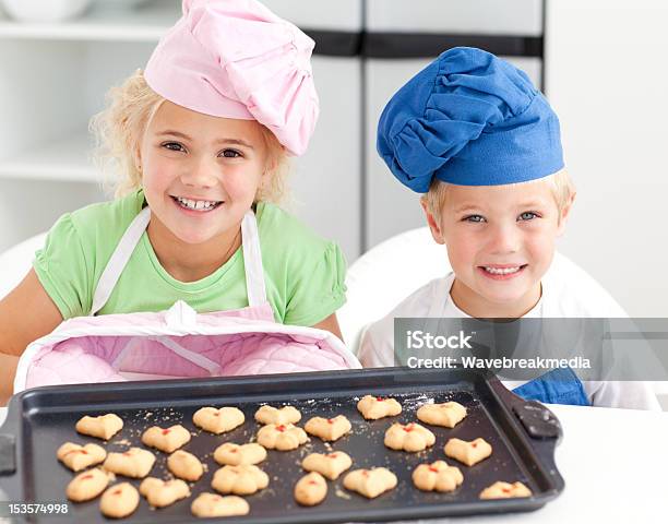 Happy Little Brother And Sister With Their Biscuits Stock Photo - Download Image Now