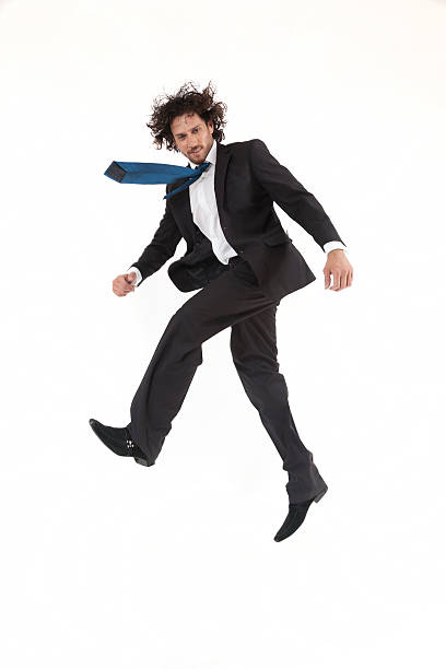 young active businessman jumping and rushing to the office stock photo