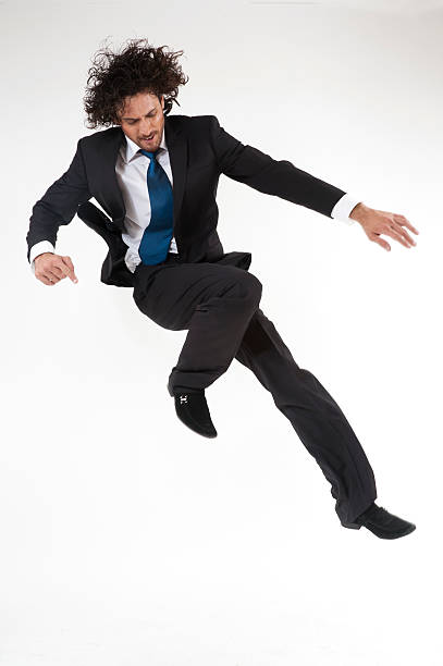 young active businessman jumping and rushing to the office stock photo