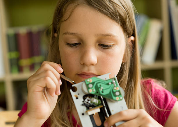 istock A young scientist looking at a circuit board 153575575