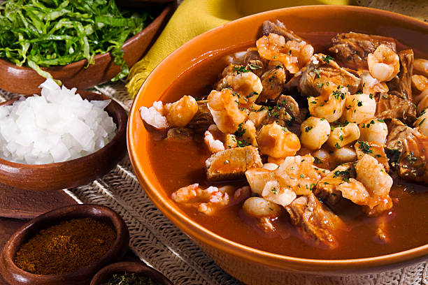Close-up of Mexican red pozole served in orange bowl stock photo
