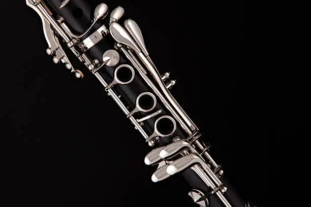 A soprano clarinet isolated against a black background