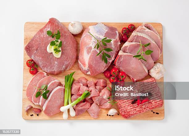Different Type Of Raw Meat On A Chopping Board Garnished Stock Photo - Download Image Now