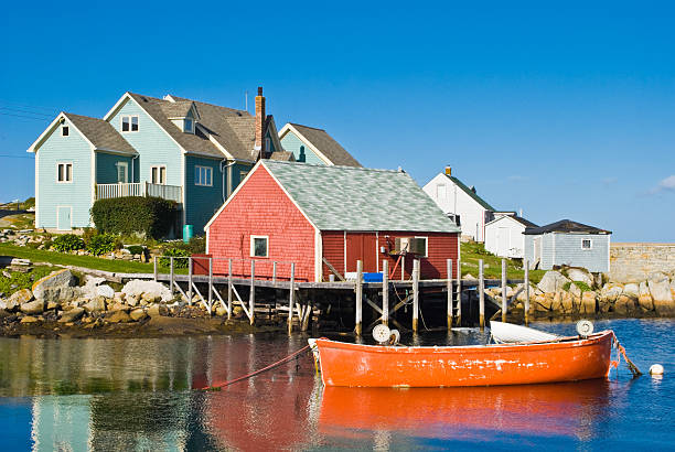 Fisherman's house and boats Fisherman's house and boats in a bay. Peggy's cove, Canada.Fisherman's house and boats in a bay. Peggy's cove, Canada. peggys cove stock pictures, royalty-free photos & images