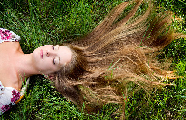 istock young beautiful girl lie in grass 153577885