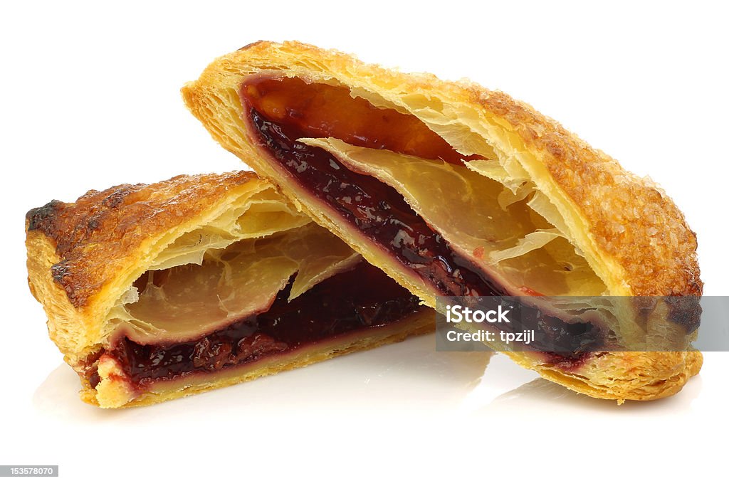 two halves of traditional  dutch filled pastry with cherry jam two halves of traditional  dutch filled pastry with cherry jam visible on a white background Baked Stock Photo