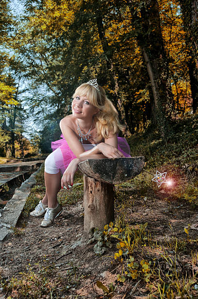 Forest fairy lying on bench with her wand