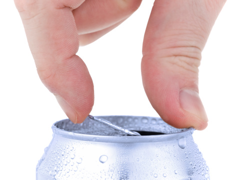 Close up of a hand opening a beverage. Isolated on white.