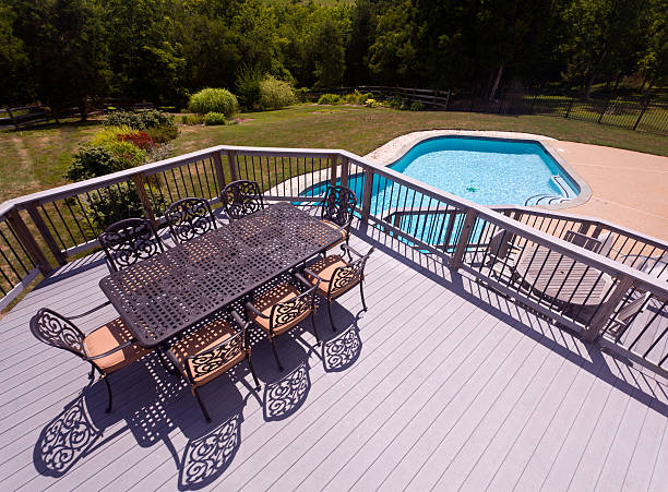 istock Seat and chairs on deck by swimming pool 153578758