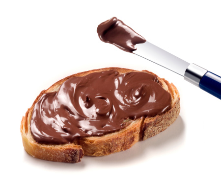 chocolate cream on a slice of bread and knife