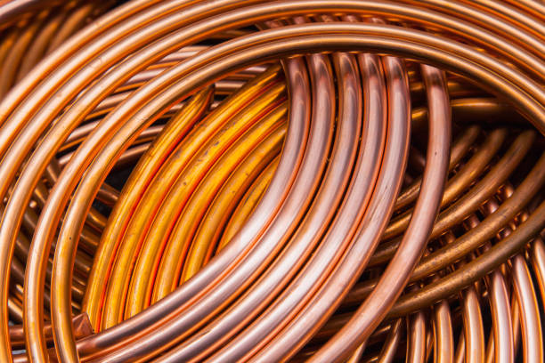 istock Twisted new copper tubes on a black background. 1535795513