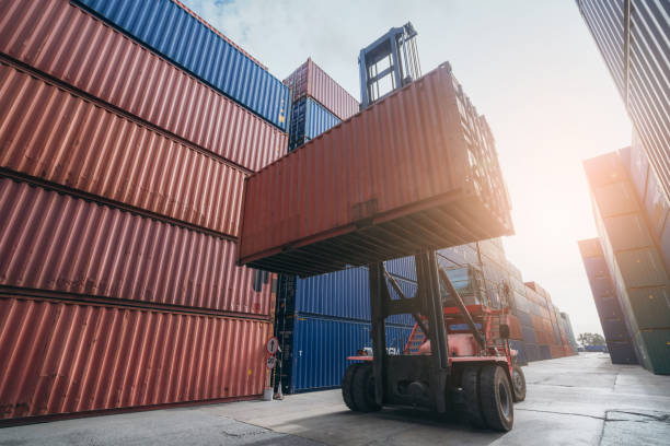 istock Forklift working in at Container cargo harbor. Logistics concept inside the shipping, import, and export industries. 1535831524