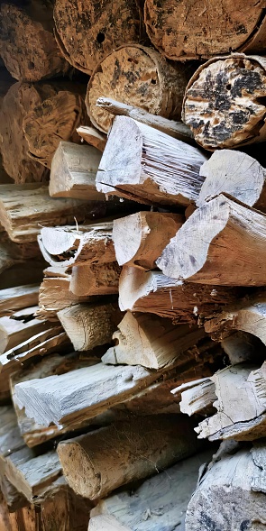 a photography of lumbermill stacked up in a pile with a few pieces of wood.