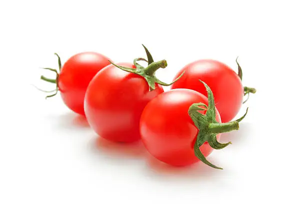 Fresh ripe cherry tomatoes closeup  isolated on white background