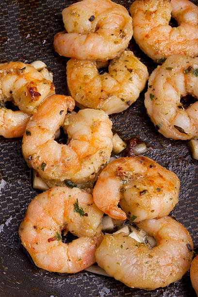 istock frying shrimps with olive oil and garlic 153587250