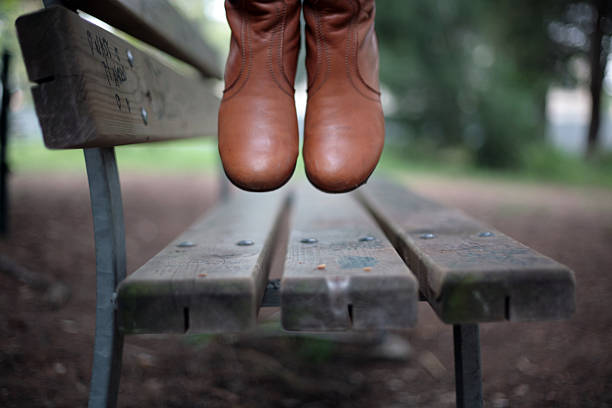 young woman jumping in the park stock photo