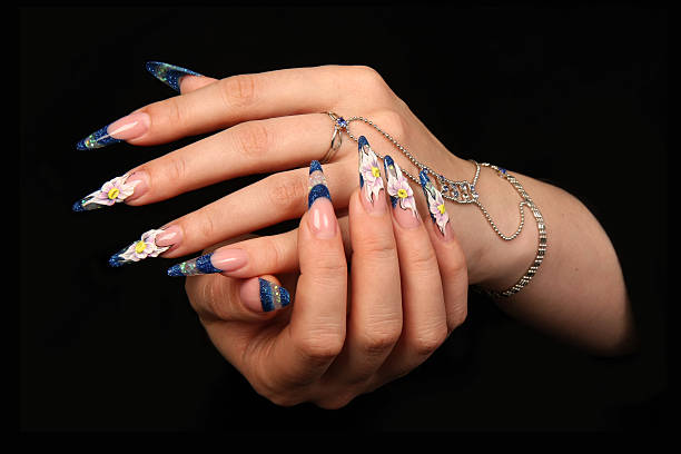 istock Human fingers  and beautiful manicure isolated on black 153588120