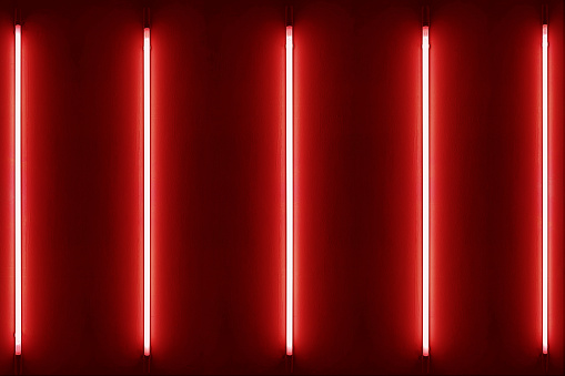 Five red neon bulbs on white wall