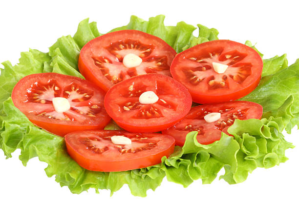 istock Sliced tomatoes with garlic on lettuce leaves 153589696