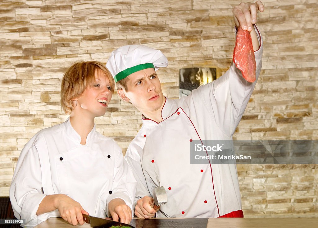 Portrait of happy couple preparing meat How do you find this beefsteak? Adolescence Stock Photo