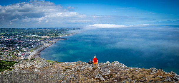 Bray, Ireland - June 11th 2023: View from the summit of Bray Head with sea mist rolling over the coastline