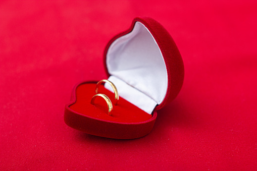 Wedding rings in a red love box with red background nuance