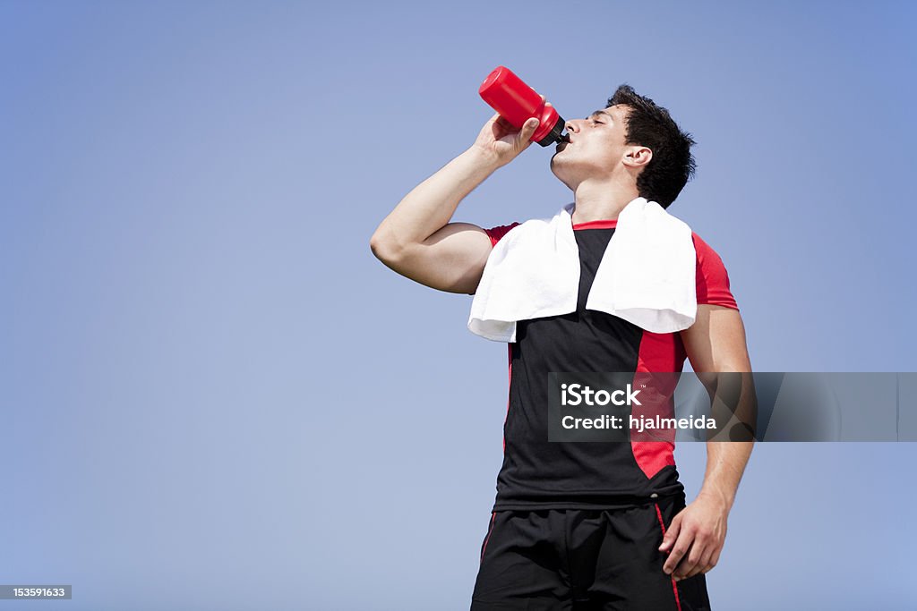 Athlete drinking water Tired athlete refreshing him self with fresh water Drinking Stock Photo